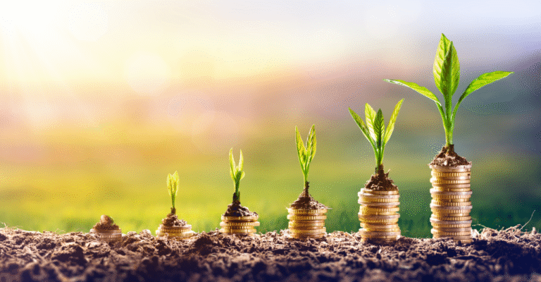 A small green plant growing out of a glass full of coins representing retirement savings with Pillar 3a in Switzerland